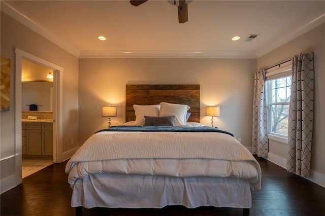 bedroom with connected bathroom, hardwood / wood-style floors, and crown molding