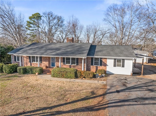 ranch-style house with a front lawn