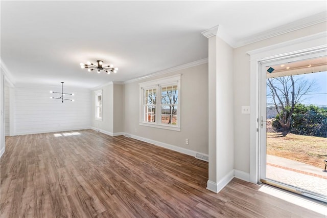 entrance foyer with a notable chandelier, wood-type flooring, and a wealth of natural light