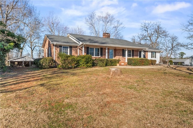 ranch-style home featuring a carport and a front lawn