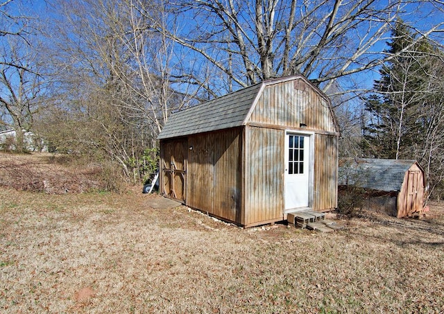 view of outbuilding with a yard