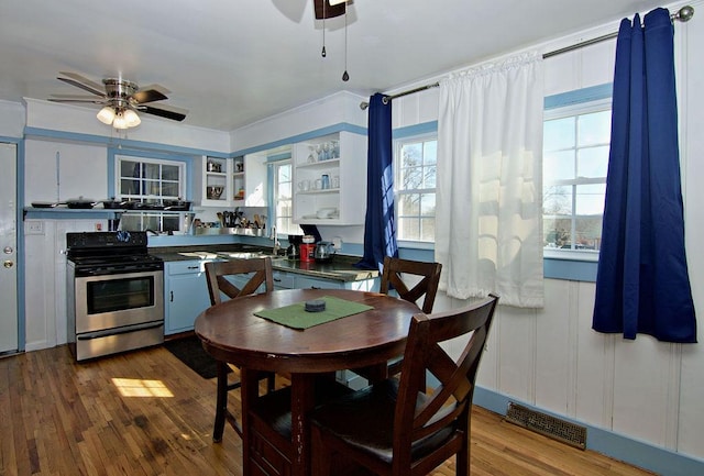 kitchen with white cabinetry, stainless steel electric range oven, dark hardwood / wood-style floors, and ceiling fan