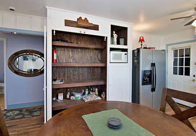 dining space featuring hardwood / wood-style flooring and ceiling fan