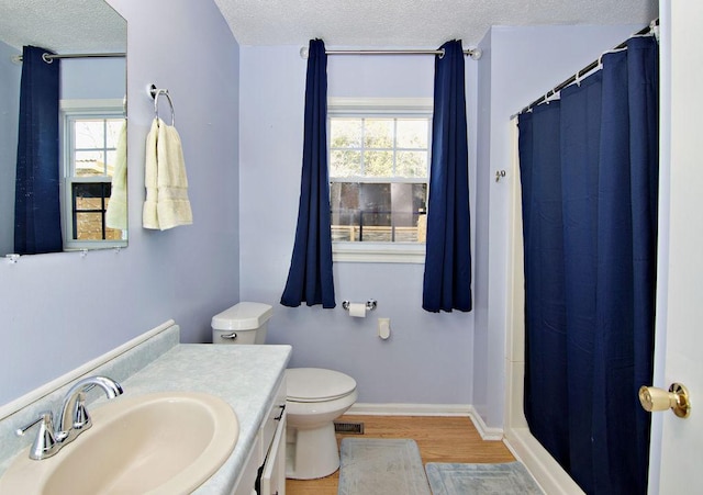 bathroom featuring toilet, a shower with curtain, a textured ceiling, vanity, and hardwood / wood-style floors