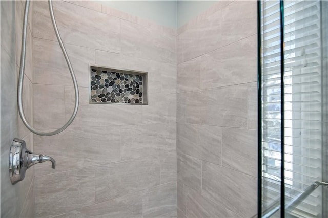 bathroom with a tile shower