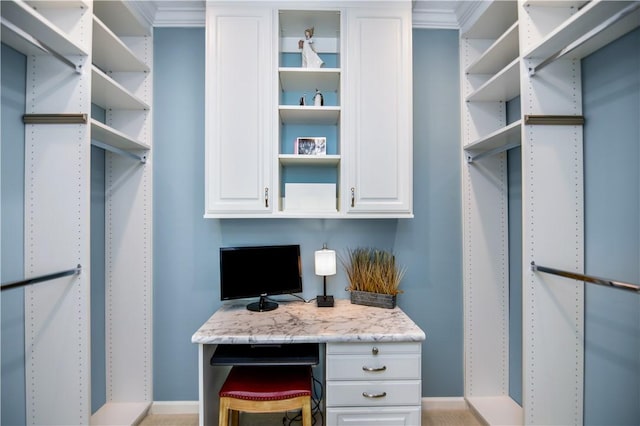 walk in closet featuring built in desk