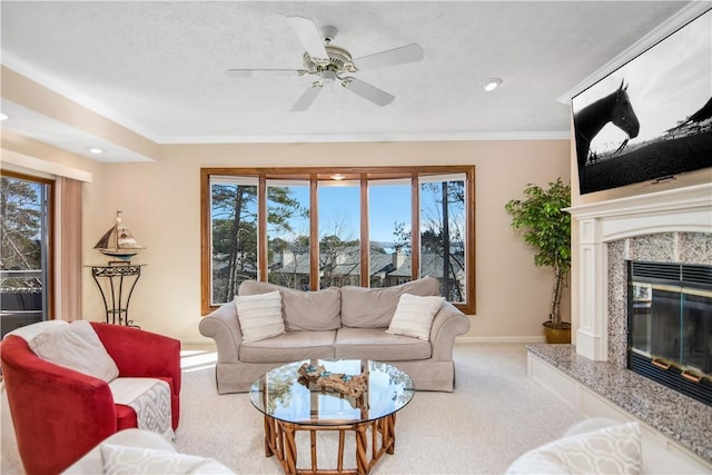 carpeted living room with crown molding, a healthy amount of sunlight, a premium fireplace, and a textured ceiling