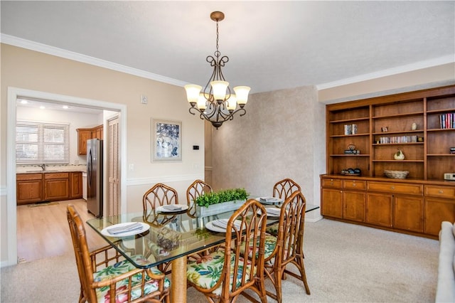 dining area with ornamental molding, light colored carpet, and a chandelier