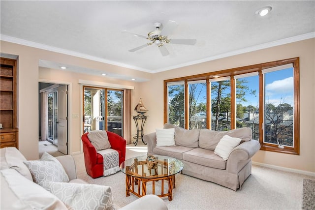 carpeted living room featuring ornamental molding and ceiling fan