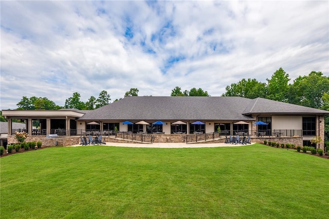 rear view of property with a lawn