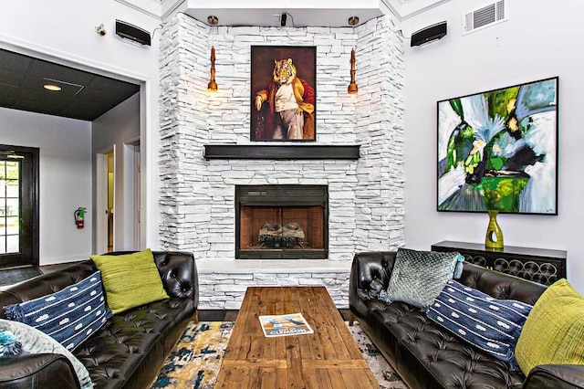 living room with a stone fireplace