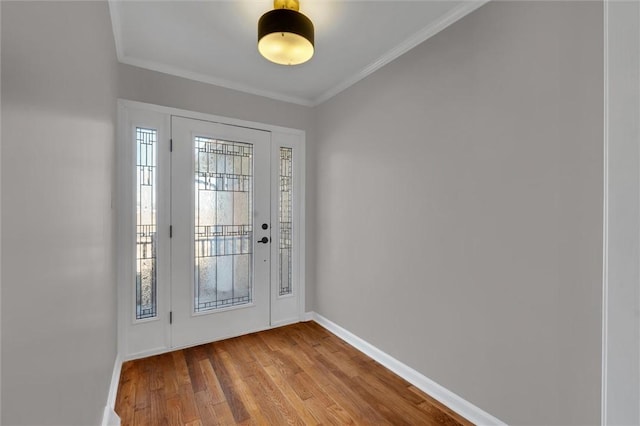 entrance foyer with ornamental molding and light wood-type flooring