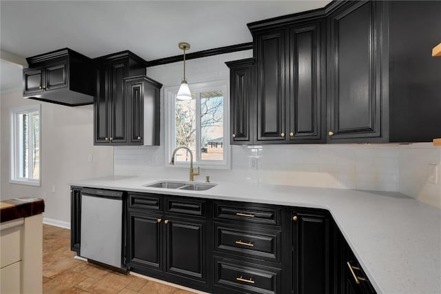 kitchen with pendant lighting, a wealth of natural light, tasteful backsplash, sink, and stainless steel dishwasher