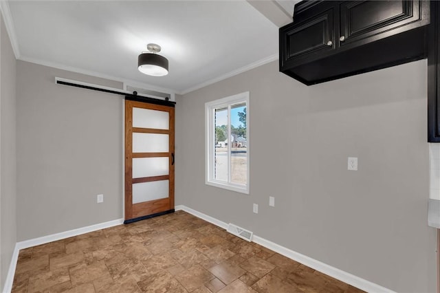 interior space featuring crown molding and a barn door