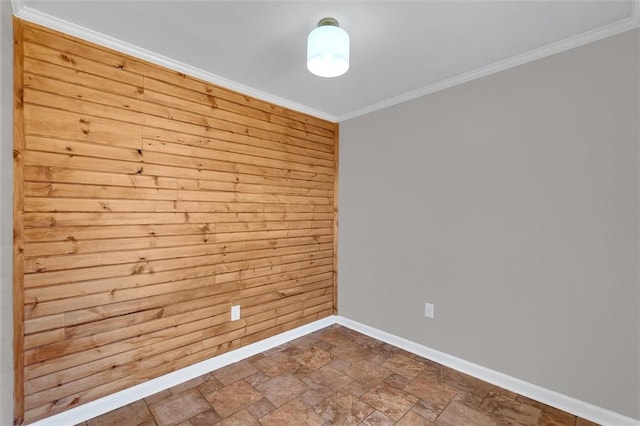 empty room featuring ornamental molding and wooden walls