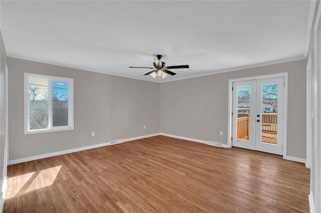 unfurnished room with french doors, ceiling fan, ornamental molding, and light hardwood / wood-style flooring