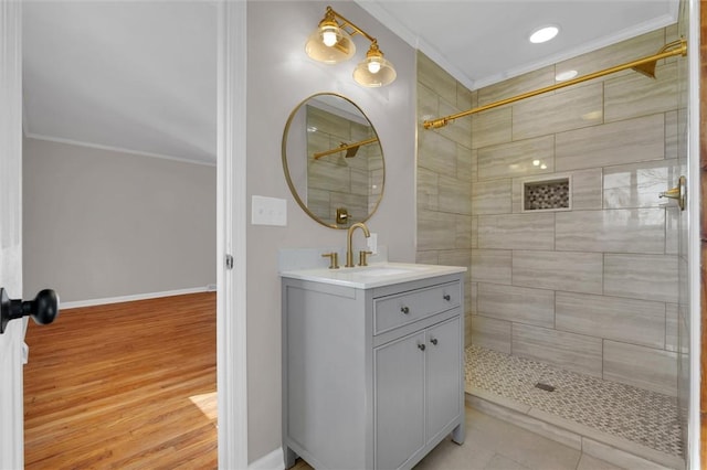 bathroom with vanity, hardwood / wood-style floors, and crown molding