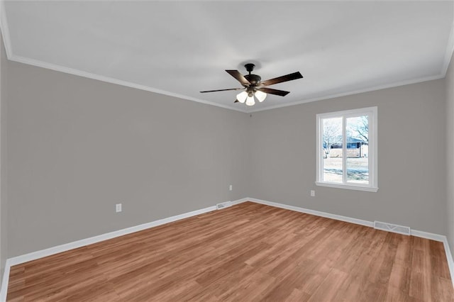 empty room with light hardwood / wood-style flooring, ornamental molding, and ceiling fan