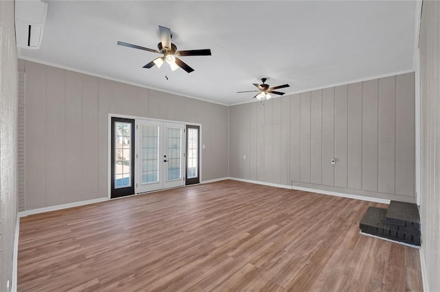 unfurnished room with ornamental molding, light hardwood / wood-style flooring, ceiling fan, and french doors