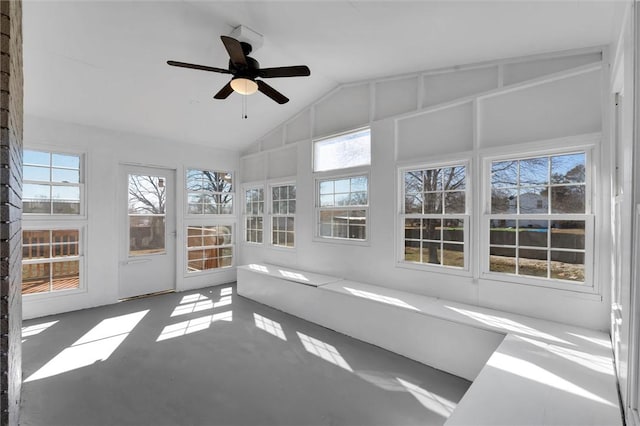 unfurnished sunroom featuring lofted ceiling, ceiling fan, and a healthy amount of sunlight