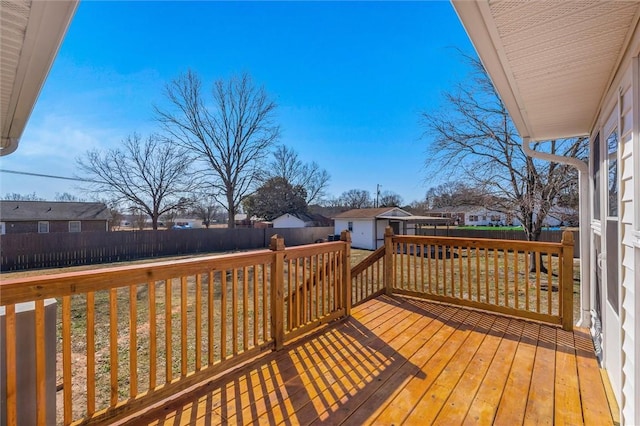 deck featuring an outdoor structure and a lawn