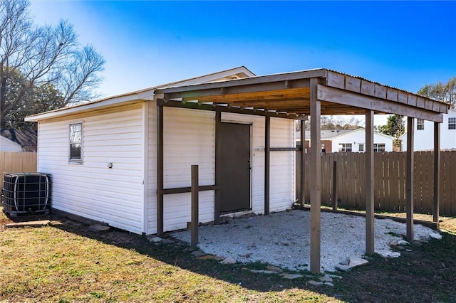 view of outdoor structure with central AC and a lawn