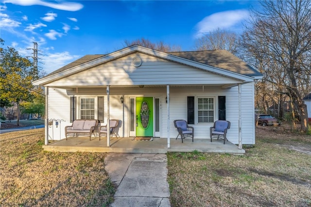 bungalow-style house featuring a porch and a front lawn