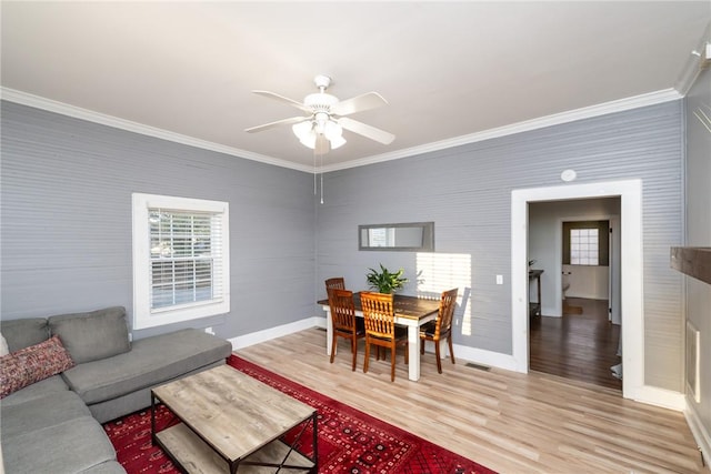 living room featuring hardwood / wood-style floors, crown molding, and ceiling fan