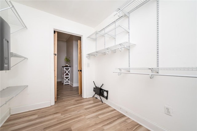 laundry room featuring light wood-type flooring