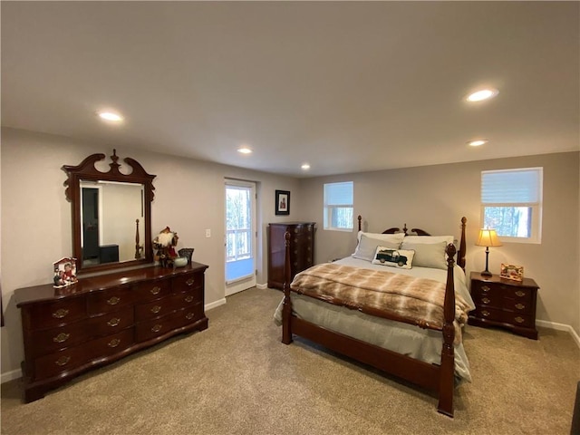 bedroom with light carpet, multiple windows, and access to outside