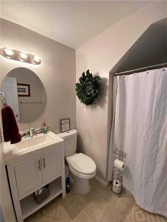 bathroom featuring tile patterned flooring, vanity, and toilet