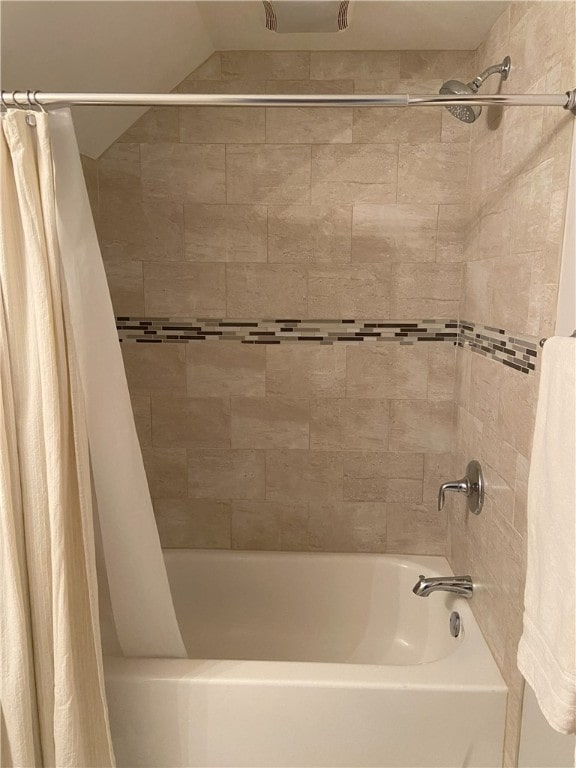 bathroom with shower / bath combo with shower curtain