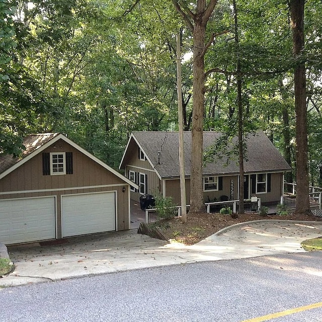 view of front of home with a garage and an outdoor structure