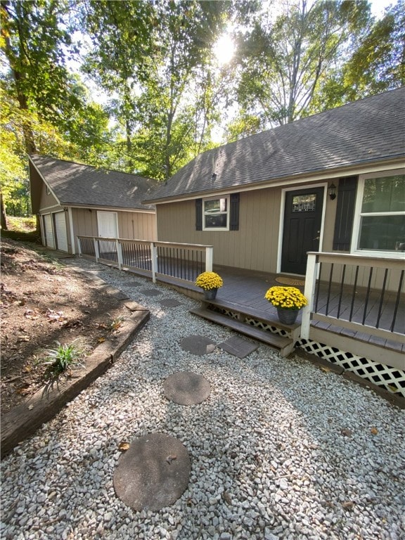 rear view of house with a wooden deck