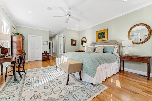 bedroom with ceiling fan, ornamental molding, and light hardwood / wood-style flooring