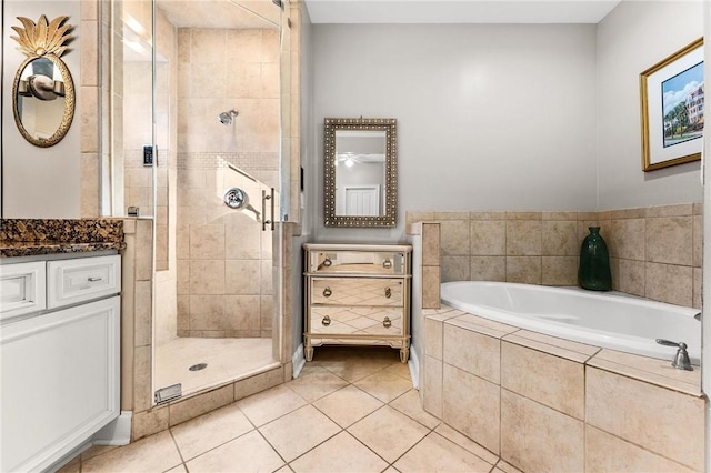 bathroom with tile patterned flooring, vanity, and shower with separate bathtub