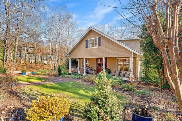 rear view of property featuring a yard