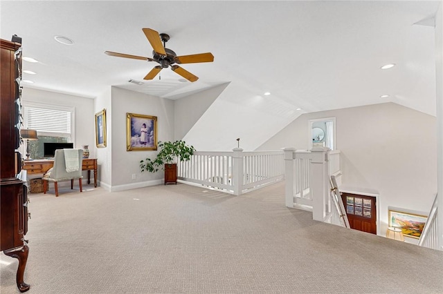 interior space featuring vaulted ceiling, light colored carpet, and ceiling fan