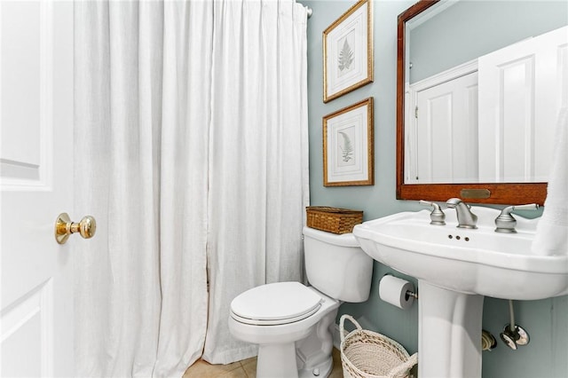 bathroom with tile patterned floors and toilet