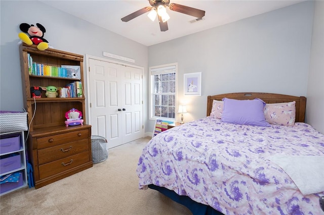 carpeted bedroom with a closet and ceiling fan