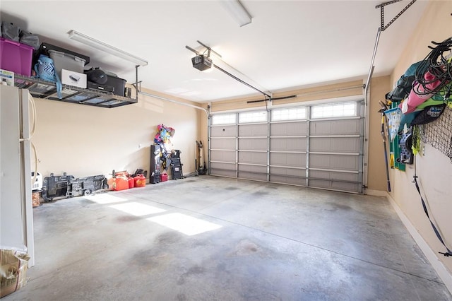 garage featuring a garage door opener and white fridge