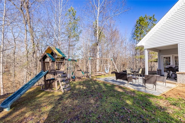 view of yard featuring a playground and a patio area