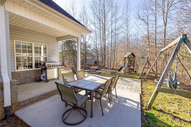 view of patio with a playground and a grill