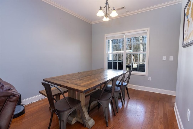 dining room featuring ornamental molding, dark hardwood / wood-style floors, and a chandelier