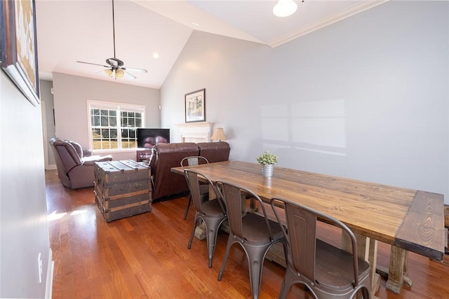 dining space with hardwood / wood-style flooring, ceiling fan, and lofted ceiling