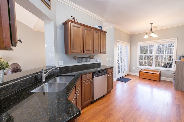 kitchen with dishwasher, sink, dark stone counters, crown molding, and light wood-type flooring