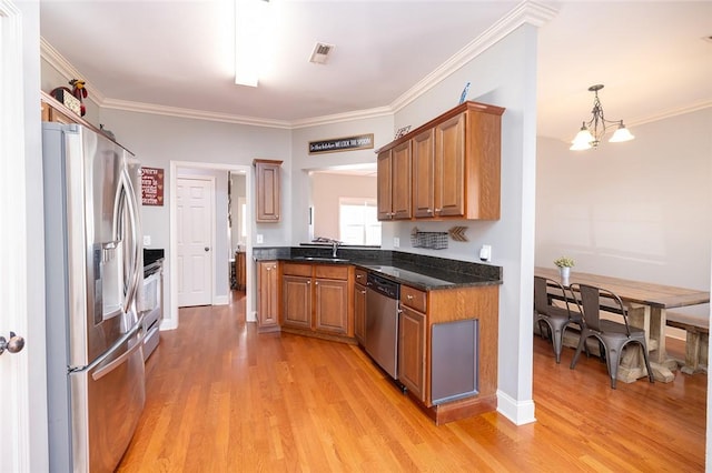 kitchen with crown molding, light hardwood / wood-style flooring, appliances with stainless steel finishes, hanging light fixtures, and a notable chandelier