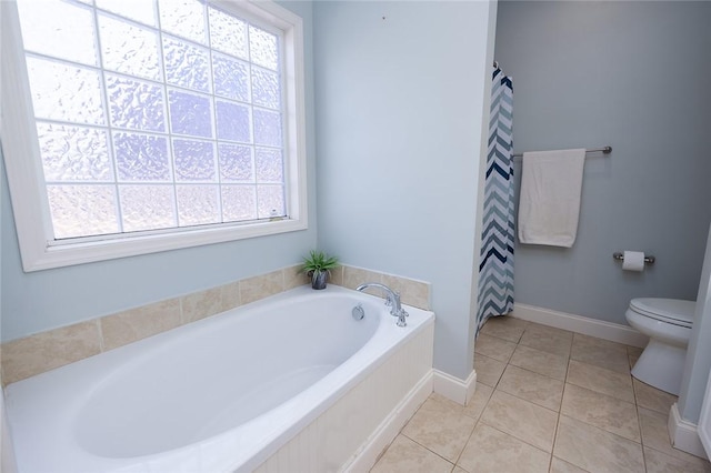 bathroom with toilet, tile patterned flooring, and a washtub