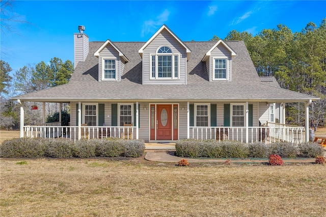 farmhouse-style home featuring covered porch and a front lawn