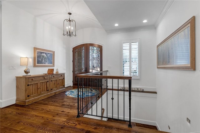 hallway featuring ornamental molding, a chandelier, dark hardwood / wood-style flooring, and french doors